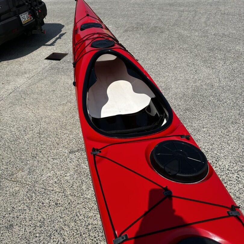 Red sea kayak on dockside pavement